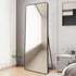 Black rounded edge freestanding mirror styled in a bedroom