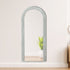 White arched mirror styled in a bright modern bedroom