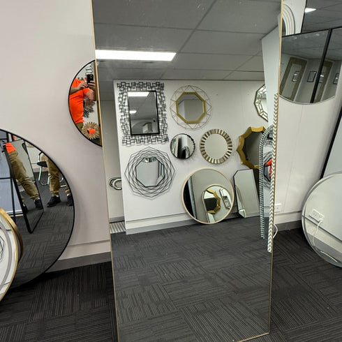 Oversized full length gold mirror leaning