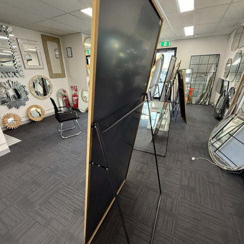 Side angle of oversized Navi gold standing mirror with slimline frame