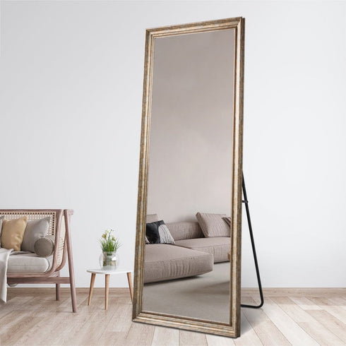 Angled view of Florinelle full-length bronze mirror showing frame and reflection