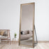 Angled view of Florinelle full-length bronze mirror showing frame and reflection
