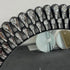 Close-up of water drop texture on silver acrylic mirror frame