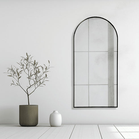 Front view of Aven arched black wall mirror in living room