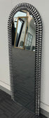Slim profile side view of arched mirror with silver acrylic frame