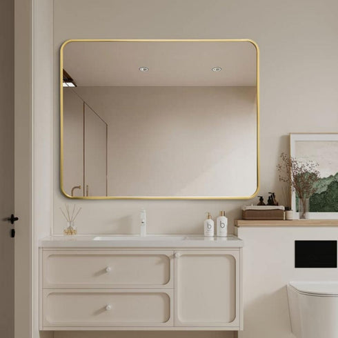 Tayla Rounded Edge Gold Wall Mirror styled above a modern bathroom vanity