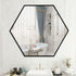 Hexagon wall mirror styled in a modern bathroom