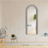 Full-length decorative mirror adding depth and elegance to a modern bedroom