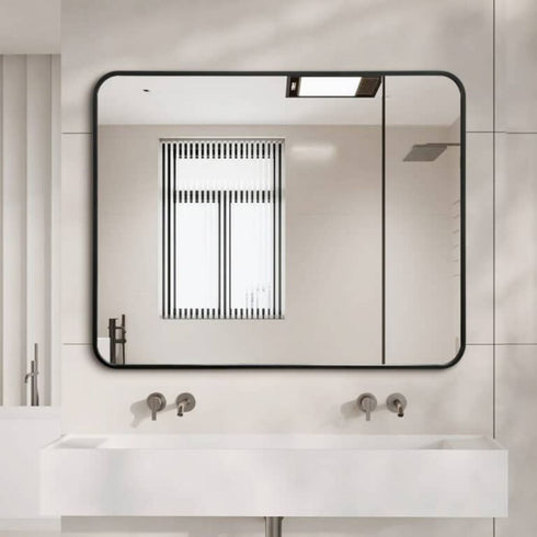 Tayla Rounded Edge Black Wall Mirror above a modern bathroom vanity