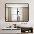 Rectangular black framed mirror styled in a contemporary bathroom