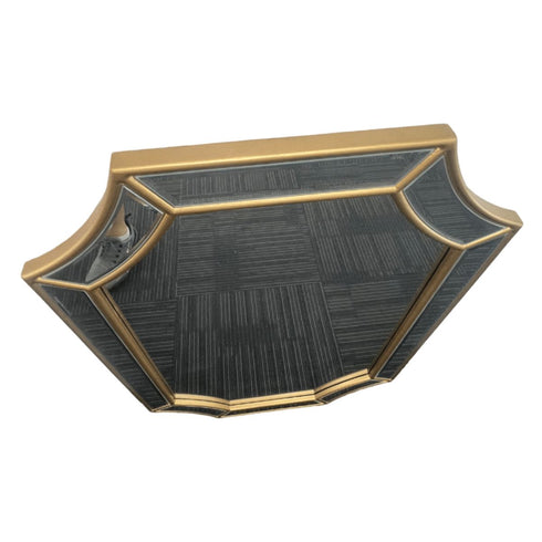 Angled side shot of artistic freeform gold mirror