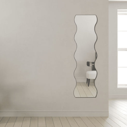 Wall-mounted black wavy decorative mirror in modern interior