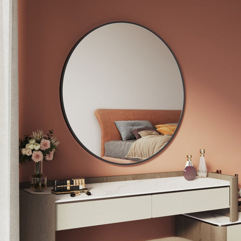 Side angle showing slim profile of black round wall-mounted mirror