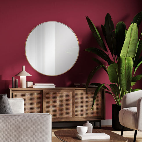 Celina Gold Round Wall Mirror in a modern living room