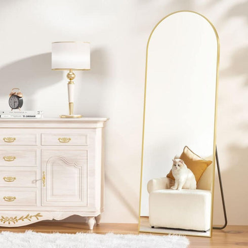Minimalist Levi arched standing mirror with freestanding rose gold frame, offering full-length reflections for any room