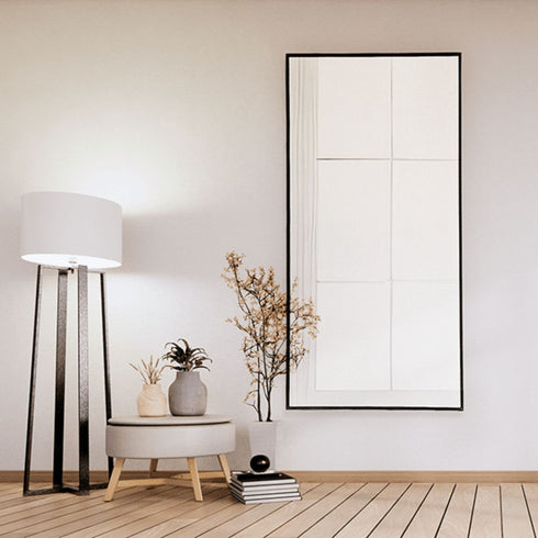 Elric black framed wall mirror adding brightness and space to a bedroom interior