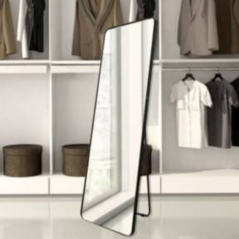 Freestanding Caelan black mirror placed in dressing area for outfit checks