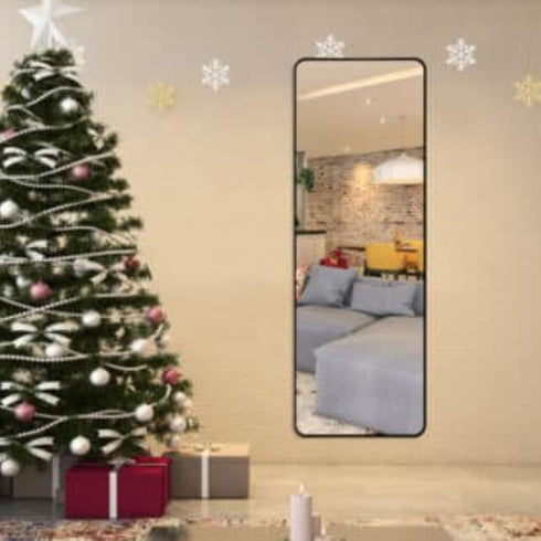 Rounded edge black dressing mirror hung on a wall