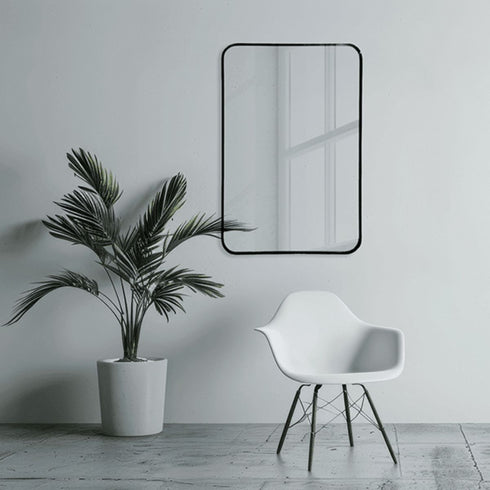 Minimalist black framed wall mirror with rounded corners
