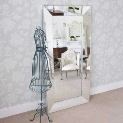 Maddox modern silver wall mirror displayed above a console table