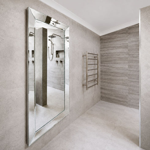 Maddox modern silver wall mirror installed in a contemporary bathroom