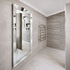 Maddox modern silver wall mirror installed in a contemporary bathroom
