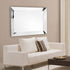 Maddox modern silver rectangular wall mirror above a sofa